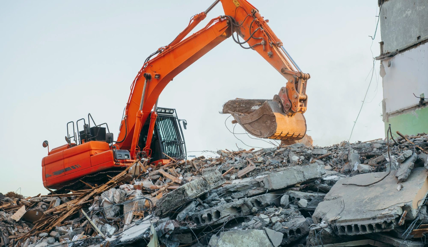 Commercial building demolition using excavator and crane on Los Angeles job site